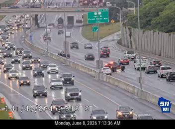 Emergency vehicles and traffic stopped on the highway, indicating an incident.