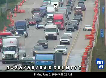 Police car and traffic cones indicate a possible incident on I-89/90/94 at County T.