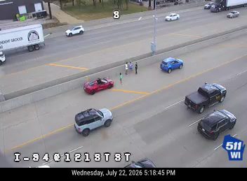 Three persons standing in the left lane
