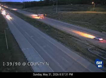 Vehicle on fire on the right shoulder of the highway.
