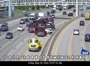Emergency responders and vehicles are present on the highway, indicating an incident.