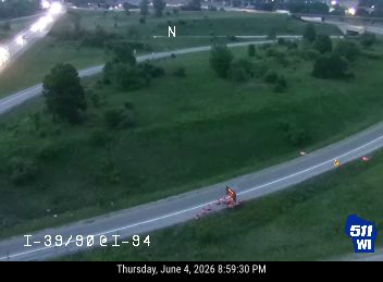 Emergency responders and cones on the right shoulder of I-94.