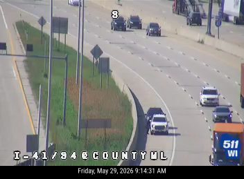 Fire truck and emergency vehicle on the right shoulder of the highway.