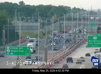 Emergency responders on the highway with cones and vehicles.