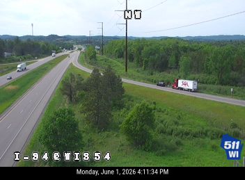 A truck and car are stopped on the shoulder, with a responder vehicle present.