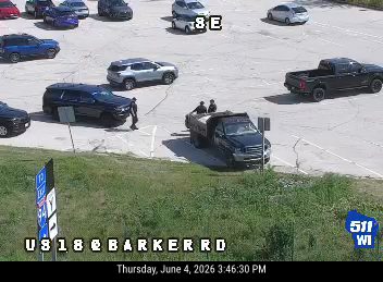Two people are standing next to a truck, possibly responding to an incident.