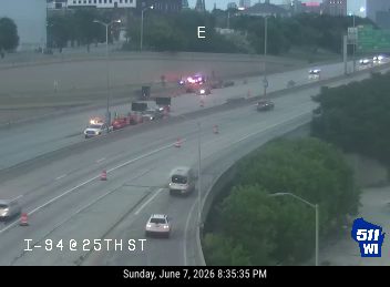 Emergency responders and vehicles are present on the highway, indicating an incident.