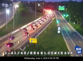 Multiple vehicles stopped in traffic, possible crash ahead.