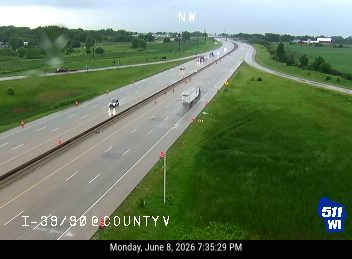 Emergency responders and cones on the highway, likely due to an incident ahead.