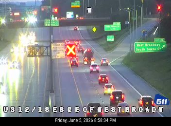 Multiple vehicles involved in a crash on the highway, blocking lanes.