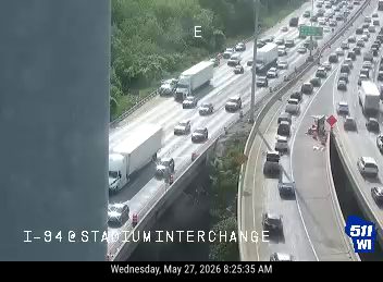 Emergency vehicle and cones on the right shoulder of I-94 at Stadium Interchange.