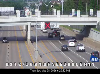Multiple vehicles involved in a crash on the highway under an overpass.