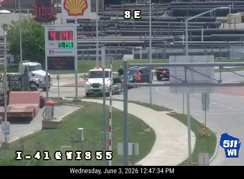Tow truck and police vehicle on the roadside with emergency lights active.