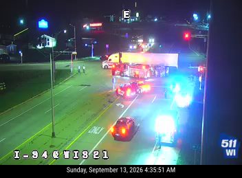 Multiple police vehicles with lights on at an intersection