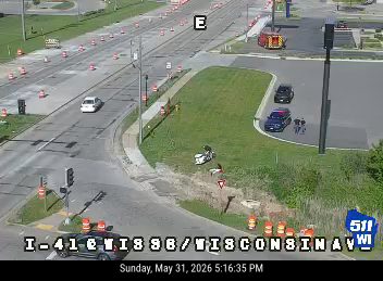 Fire truck and personnel on scene at a roadside incident.