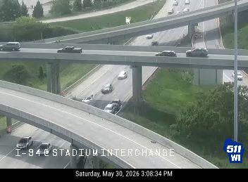 Two vehicles appear to be involved in a crash on the lower roadway.
