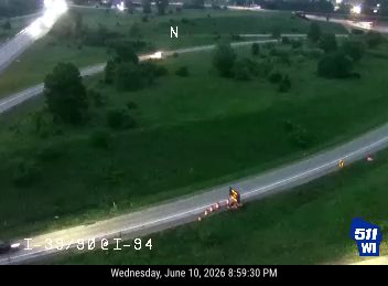 Emergency vehicle and cones on the side of the road.