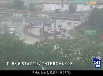 Emergency responders and vehicles are present at the I-94 Stadium Interchange.