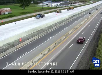 Construction equipment and workers in the right lane