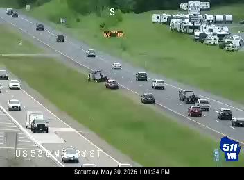 Two vehicles appear to be involved in a crash on the right shoulder of the highway.