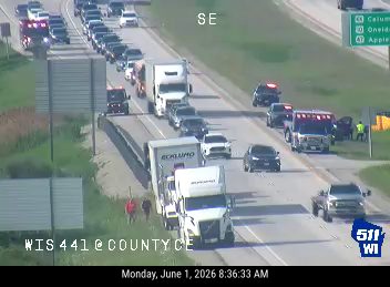 Emergency responders and vehicles are present on the side of the highway.