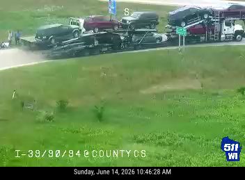 Person on the roadway near a trailer