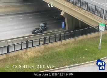 Fire truck and emergency personnel responding to an incident on I-43 at Highland Ave.