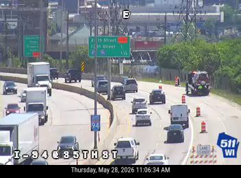 Emergency vehicle and cones on the right shoulder of I-94.