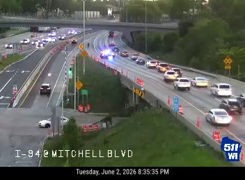 Police and emergency vehicles on I-94 at Mitchell Blvd, traffic slowed.