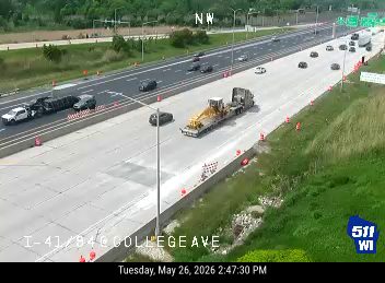 Two vehicles involved in a crash on the highway, blocking lanes.