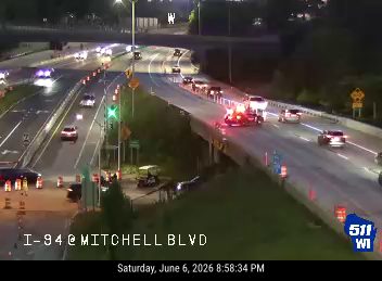 Emergency responders on I-94 at Mitchell Blvd with flashing lights.