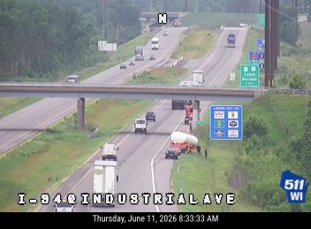 Emergency responders and vehicles are present on the shoulder of I-94 near Industrial Ave.