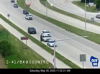 Multiple vehicles involved in a crash on the highway, blocking lanes.