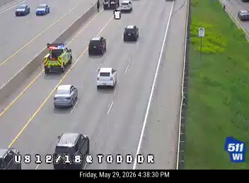 Emergency vehicle on the highway shoulder with lights on.