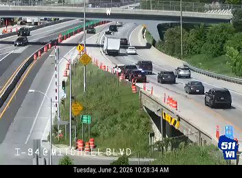 Emergency responders and vehicles are present on the roadway, indicating an incident.