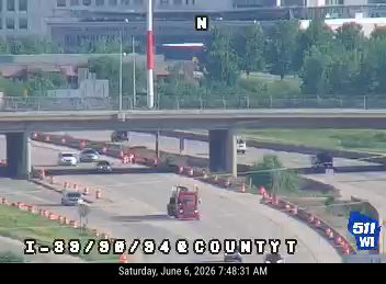 A red truck appears to be a responder vehicle on the roadway with cones present.