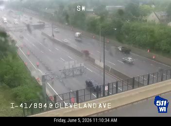 Debris on highway, possibly from a crash, blocking lanes.