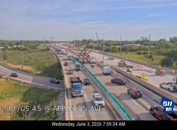 Emergency responders and equipment on highway, traffic is moving slowly.