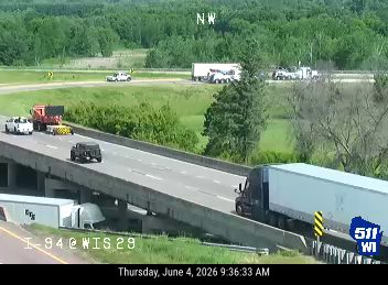 Emergency vehicle and equipment on the highway shoulder, possibly responding to an incident.