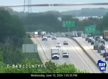 Emergency responders and vehicles are present on the roadway, indicating an incident.