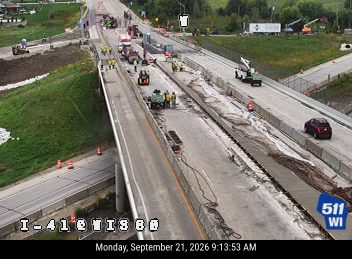 Construction activity with workers and equipment in multiple lanes