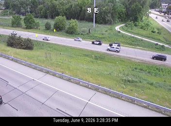 Police car and van stopped on the shoulder, possibly responding to an incident.
