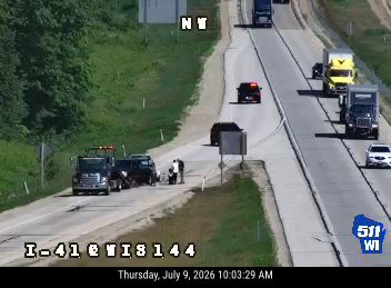 Tow truck and two vehicles on the right shoulder with emergency lights active