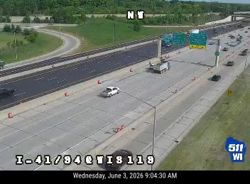 A tow truck and cones are present on the highway, indicating a possible incident response.