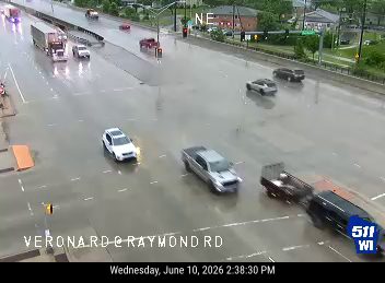 Roadway is flooded with standing water, affecting traffic flow.
