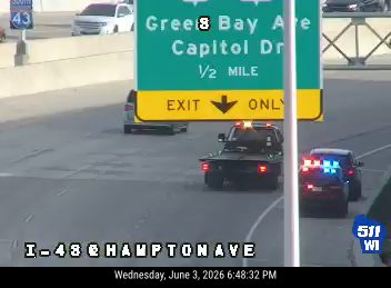 Police car with flashing lights on the right side of the road.