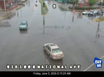 Roadway is flooded with standing water, affecting traffic flow.