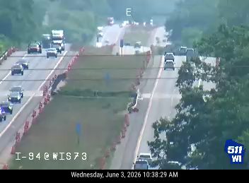 Emergency responders and vehicles on I-94 at WIS 73, traffic is backed up.