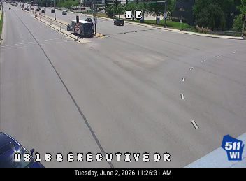 A truck appears to be stopped in the road with emergency lights, possibly a responder scene.