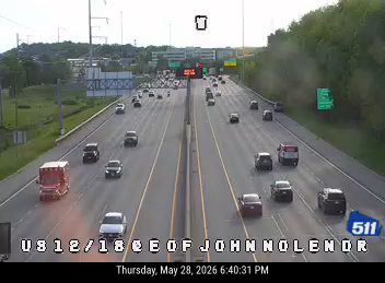 Emergency vehicle on the right shoulder of the highway, possibly responding to an incident.